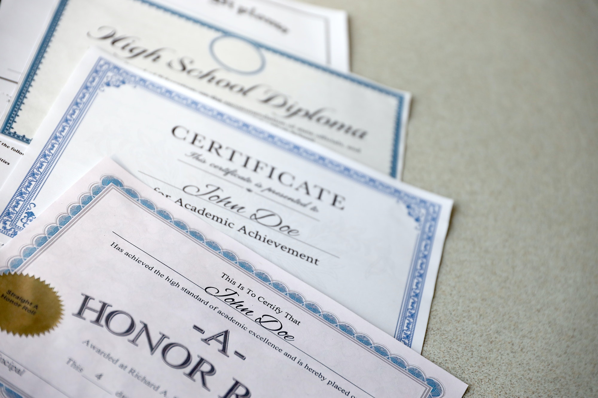 A honor roll recognition, certificate of achievement and high school diploma