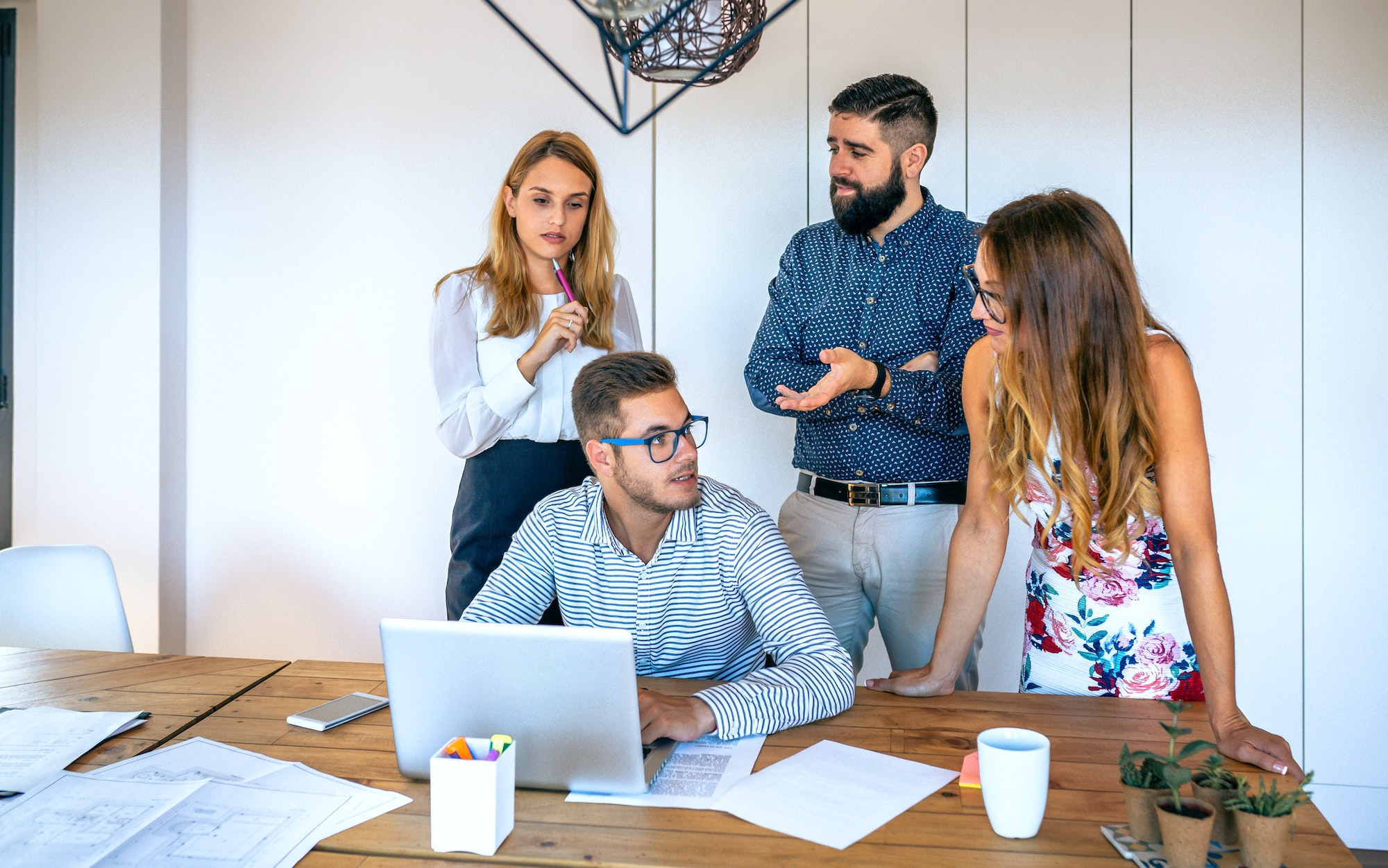 Business people in a meeting standing evaluating a trainee worker